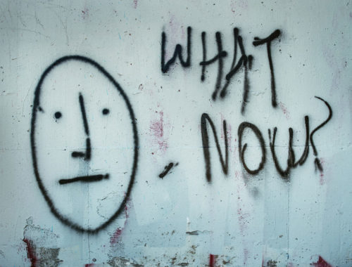 Photo of graffitti with a COVID message, "what's now?"