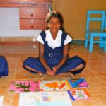 photo of a Sri Lankan student with her art supplies