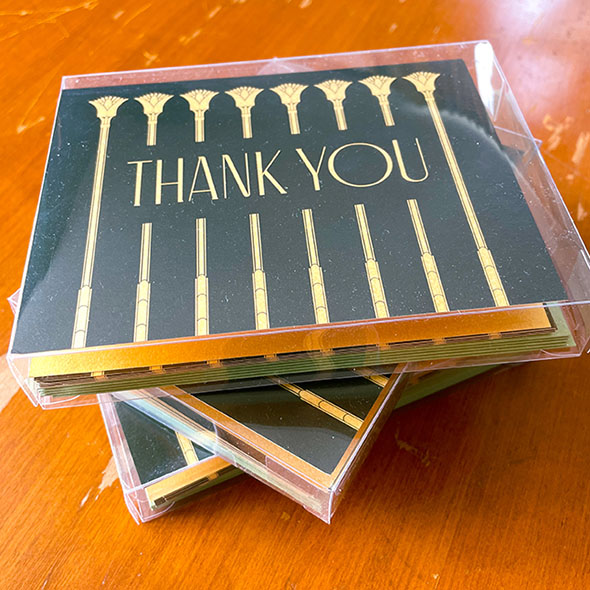 Boxes of gold and dark green thank you cards. Size A2