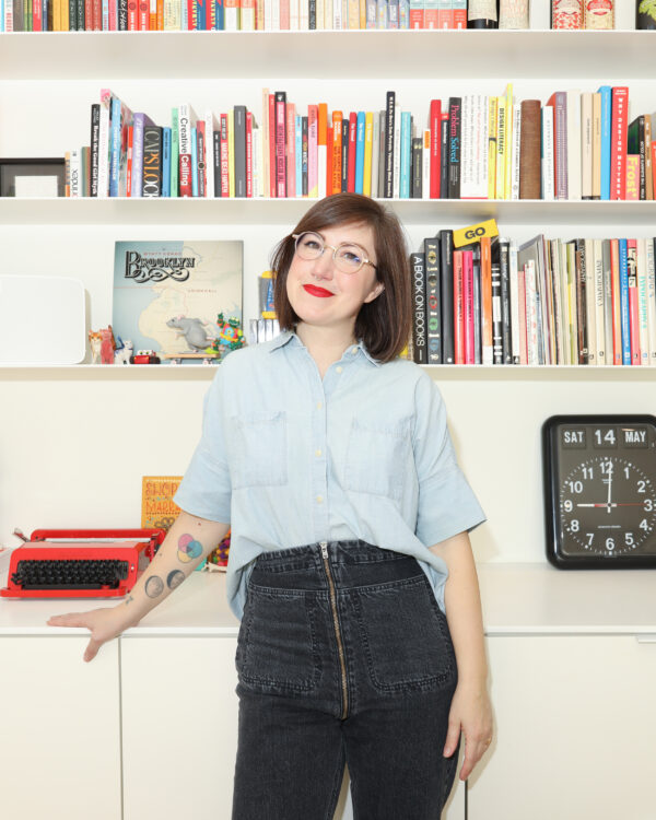 Picture of Jessica Hische in front of book shelves.